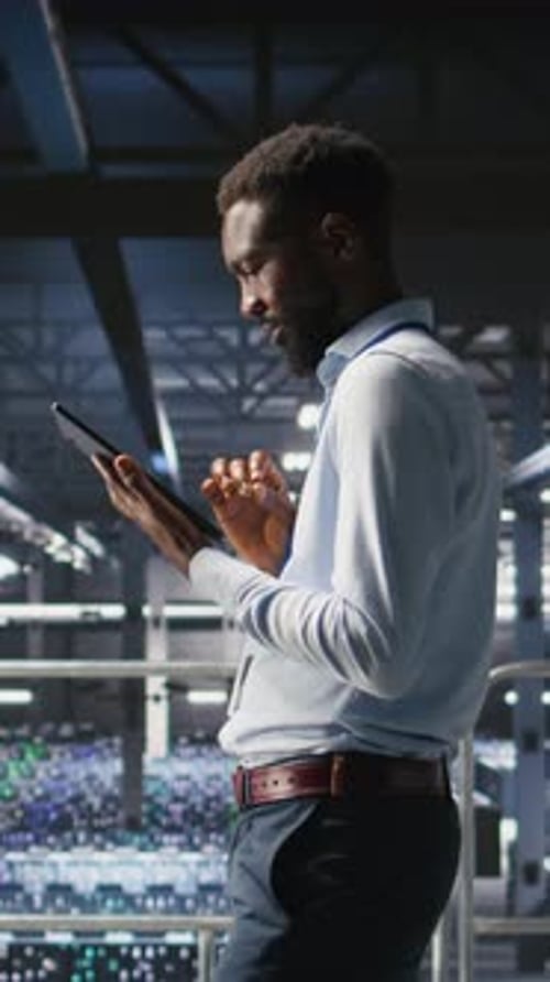 Vertical Video Data Center Engineer Doing Maintenance Tasks on Systems