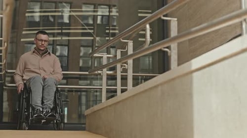 Portrait of Man in Wheelchair on Ramp in City