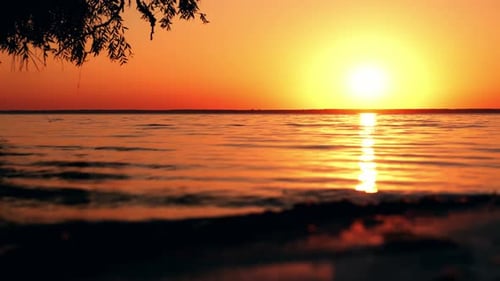 Beautiful cloudscape over the sea, bright orange sunset time lapse