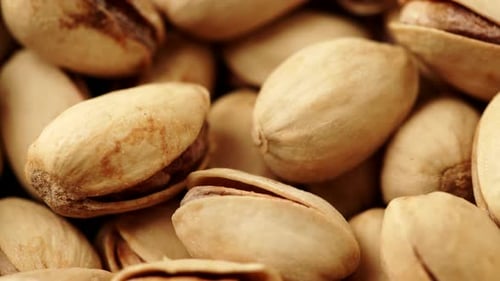 Pile of Beige and Green Pistachios Close Up
