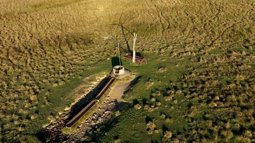 Aerial view of countryside shadoof well in meadow pasture by drone