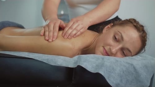 Close Up Slim Woman Relaxing During Healthcare Massage Lying on Massaging Table