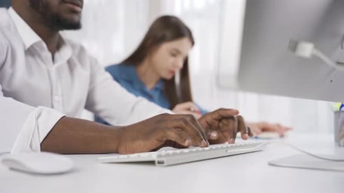 Close-up of multiethnic colleagues working together in office.