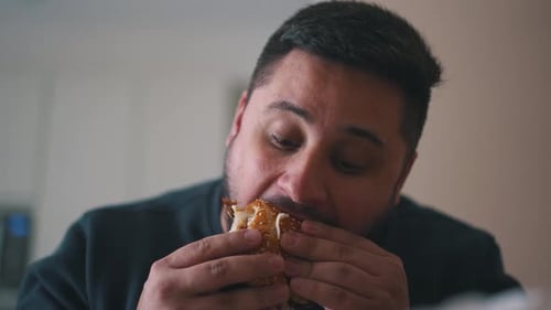 Man Enjoys Delicious Burger Inside