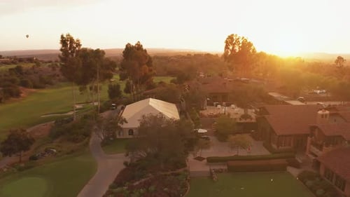 Golden hour aerial view of a country club golf house building exterior