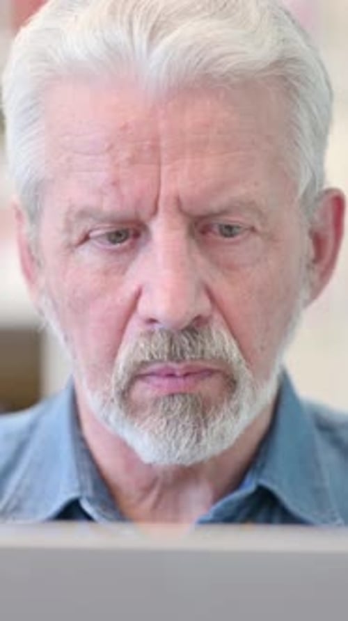 Close Up of Old Businessman Working on Laptop, vertical video