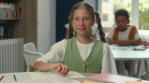 Girl Giving Thumbs Up in Classroom