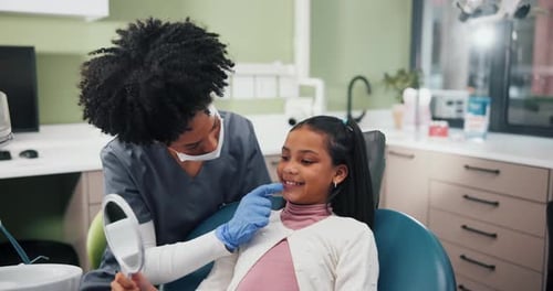 Dentist Examining Young Patient Teeth in Clinic
