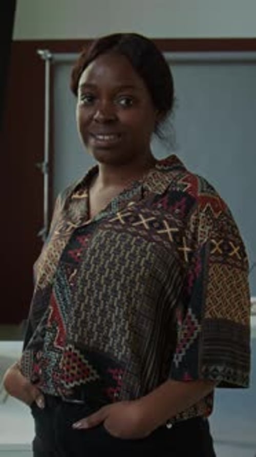 Positive Female Photographer Posing on Camera in Studio