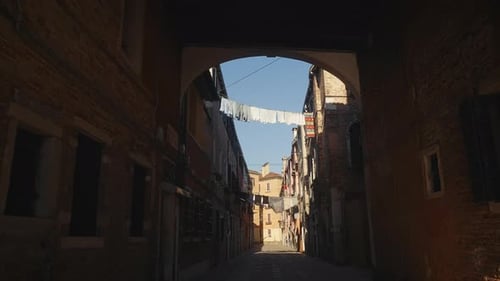 Empty Lane Between Medieval Buildings with Laundry in Venice City District