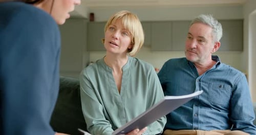 Couple Consults with Advisor in Modern Home