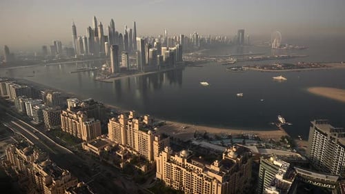 A Video Showcasing a Large Body of Water Encircled By Towering City Structures During a Vibrant