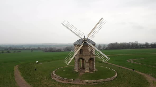 Fly-Through Shot Between the Sails of a Historic Windmill, Buildings ...