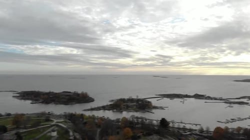 Drone pan of Helsinki, Finland. Panning right to left starting at the city, moving to the sea. Sunse
