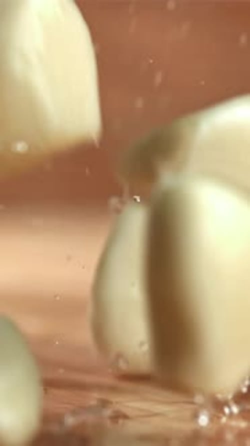 Fresh Garlic Falls on a Wet Cutting Board Filmed on a Highspeed Camera at 1000 Fps