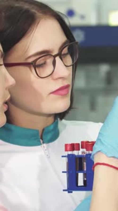 Woman Holding Test Tubes in Clinical Lab
