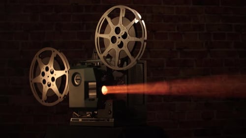Vintage Film Projector Illuminating a Brick Wall
