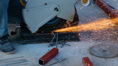 Metal Saw Cuts Through Metal Rods