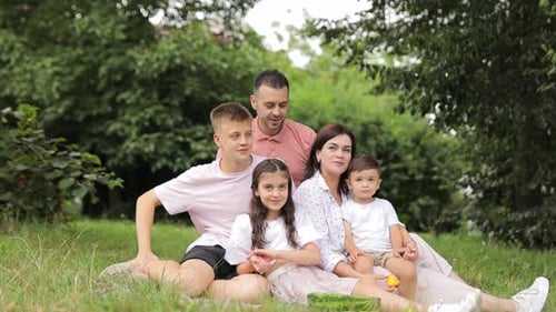 Family Relaxing Together in a Park on a Blanket