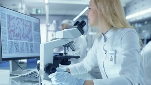 Scientist Using Microscope in Modern Laboratory