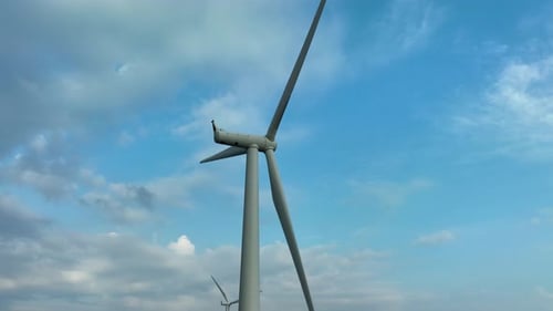 Wind Turbine Rotating in a Cloudy Sky