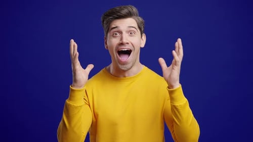 Surprised Man Reacting to Positive News on Blue