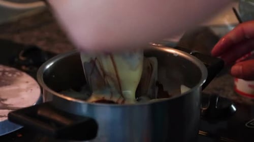 Melting and mixing butter and in a steal pot on the stove