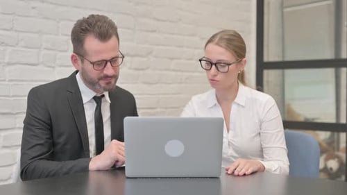 Team Working Together on Laptop in Office