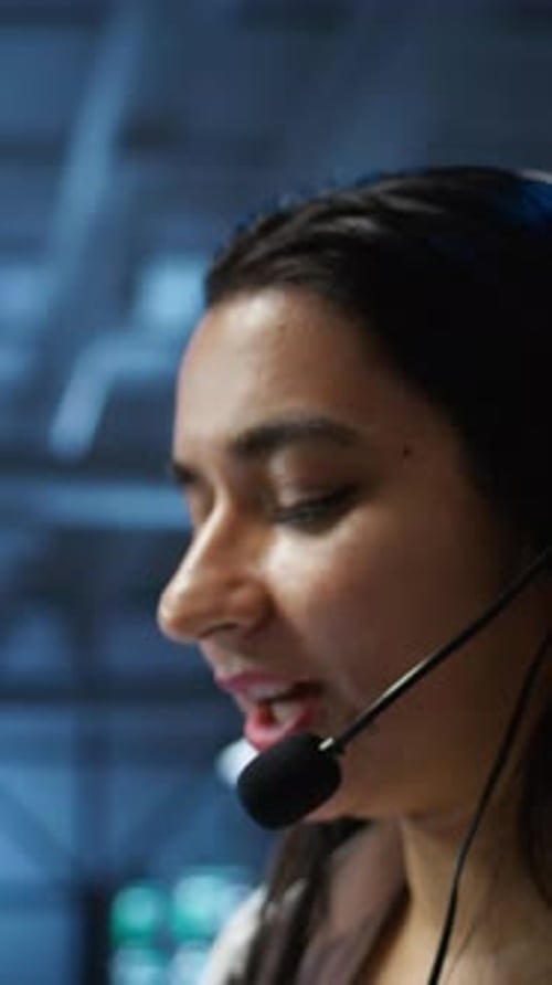 Woman in Headset Speaking in Control Room