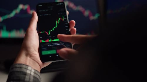 Smartphone Stock Chart Analysis at Night