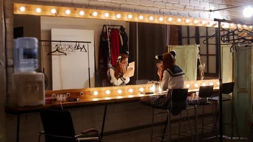 Women Applying Makeup in Dressing Room Backstage