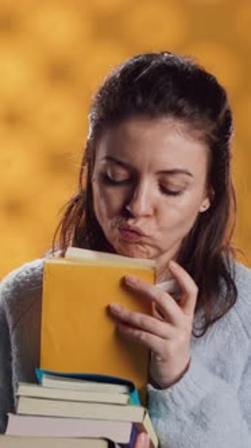 Young Woman Smiling with Colorful Stack of Books