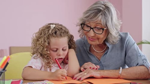 Child and Grandmother Drawing Together at a Table