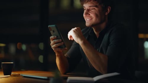 Entrepreneur Scrolling Smartphone Late Evening Workplace Closeup Happy Manager