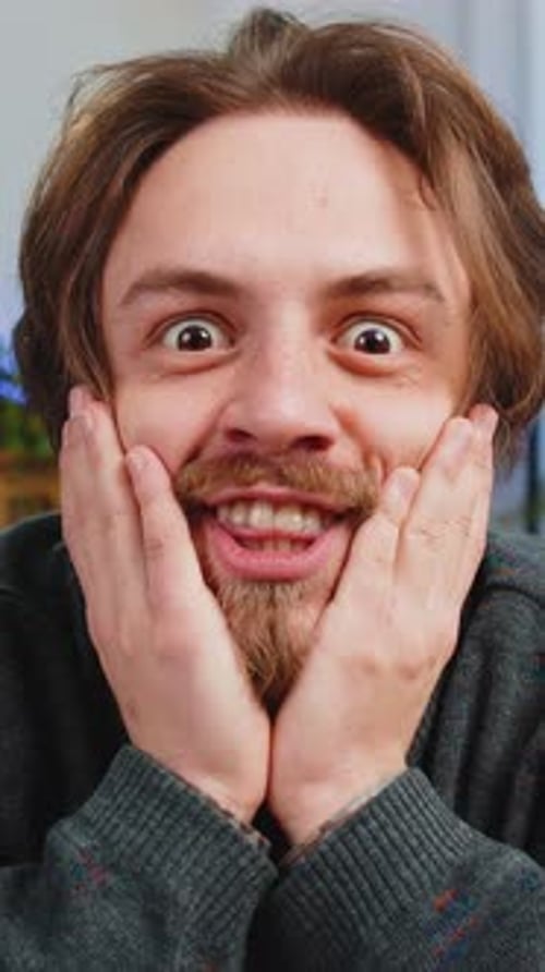 Young Man Reacts with Joy and Surprise