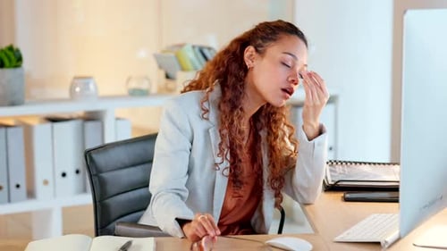 Femme d'affaires stressée souffrant d'un mal de tête alors qu'elle travaille sur un ordinateur de bureau au travail