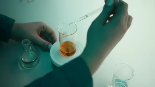 Scientist Performing Chemistry Experiment in Laboratory