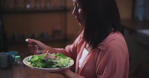Woman Eating Healthy Salad at Home