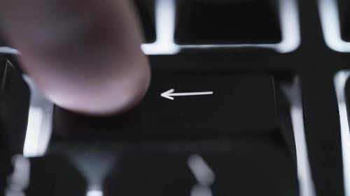 Pressing and holding backspace key on black computer keyboard
