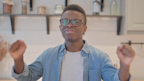 Enthusiastic Young Adult Dancing Indoors with Energy