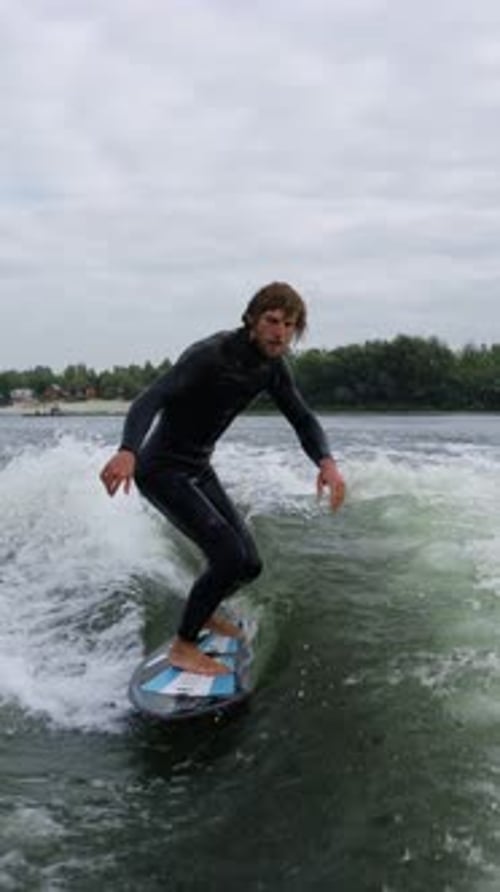 Dynamic Water Sports Performance A Surfer Executing Impressive Moves on a Surfboard Amidst Choppy
