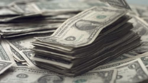 Slow motion dollar bills falling representing wealth and financial success