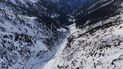 Winter Landscape of a Mountainous Valley with Snowcovered Slopes