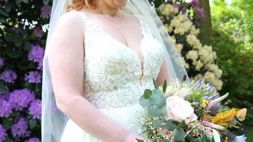 Happy smiling bride, flower bouquet, wedding celebration, garden venue