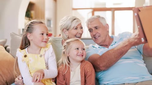 Grandparents and Grandchildren Smiling Together at Home