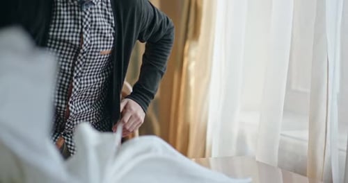 Man with dark hair sits at table looking upset