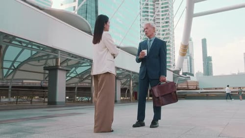 Colleagues Discuss Business Over Coffee in City