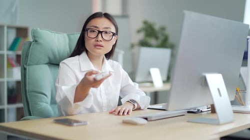 Woman employee entrepreneur. office worker Turn on a remote control air conditioner, cooling system