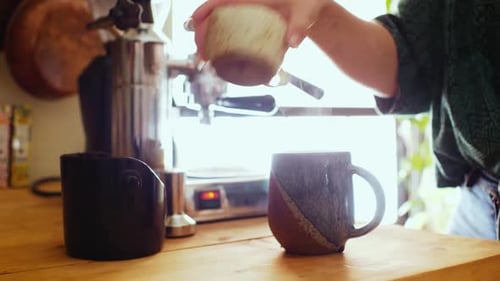Woman Preparing Coffee with Espresso Machine at Home