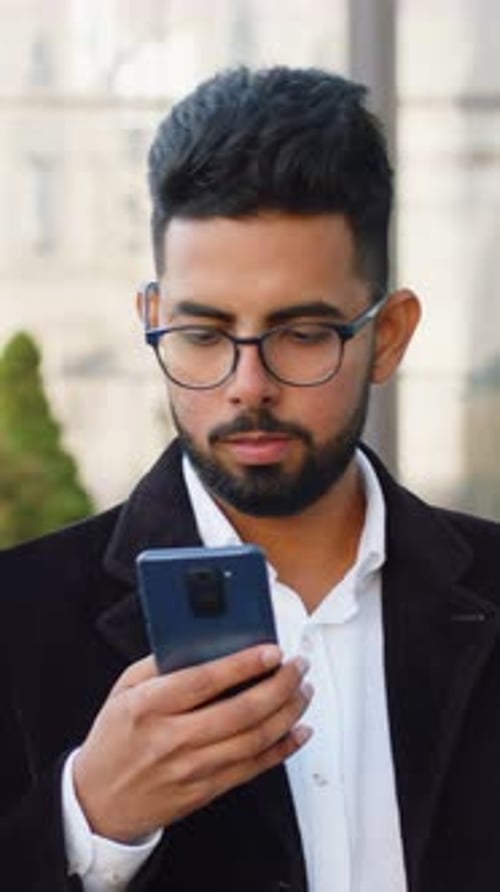 Smiling Business Man Using Smartphone Typing Text Answering Messages Chatting Online in City Street
